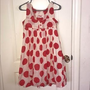 Off-white dress with red polka-dots.